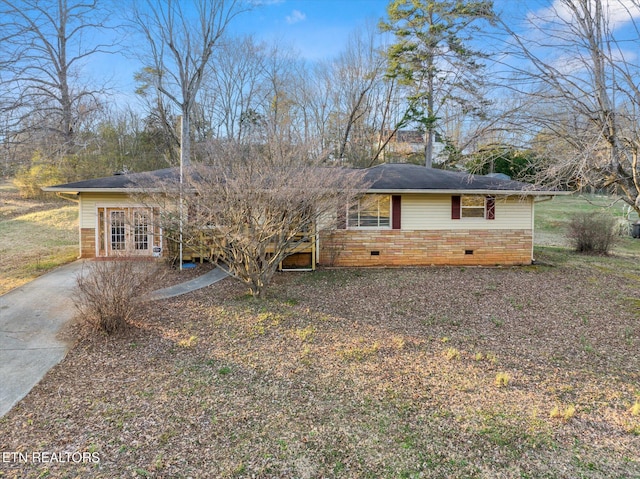 view of front facade with crawl space and concrete driveway