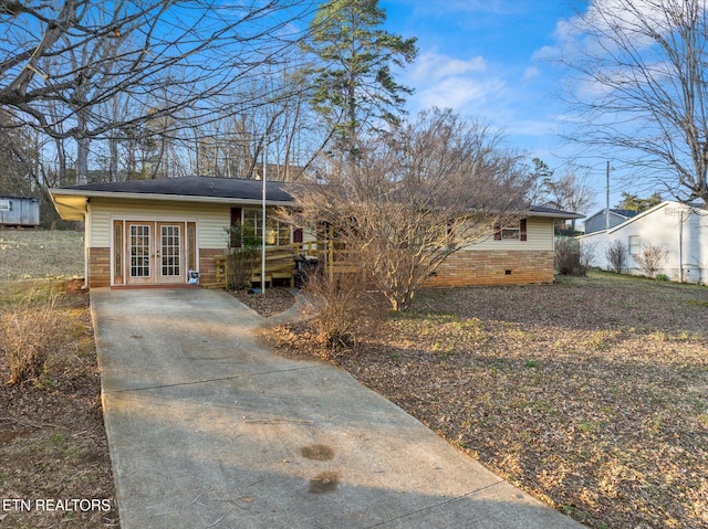 ranch-style house featuring french doors and crawl space