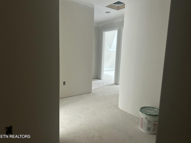 hallway with unfinished concrete floors