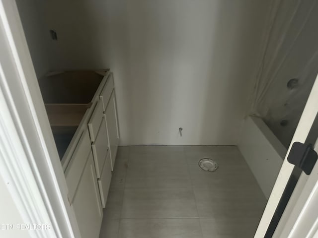 bathroom with tile patterned floors, a bathing tub, vanity, and a shower