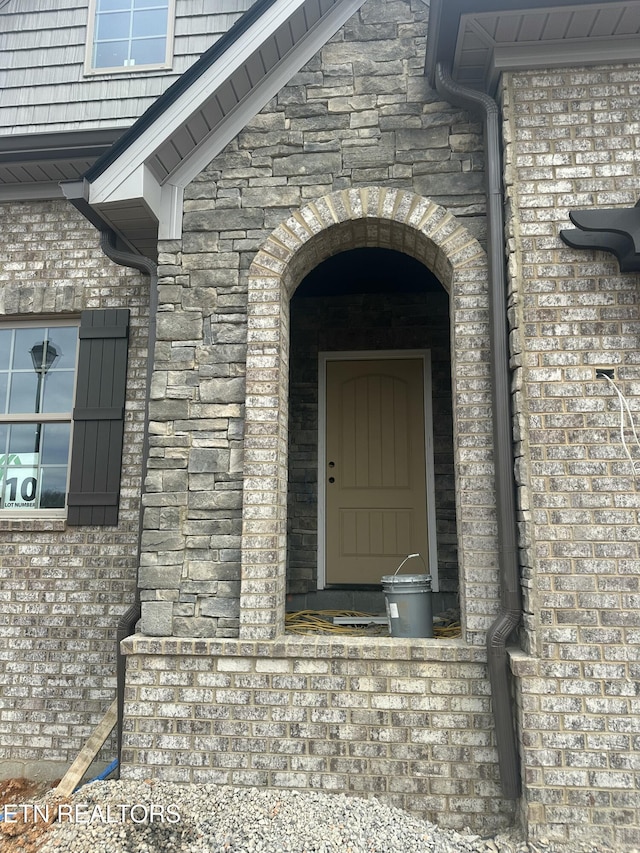 view of exterior entry featuring stone siding