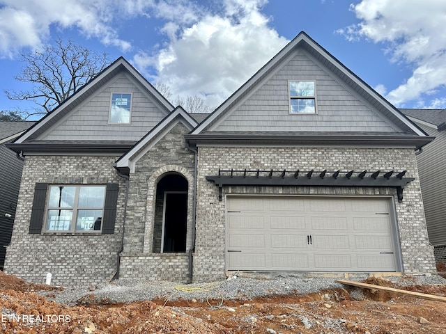 view of front of property with brick siding and a garage