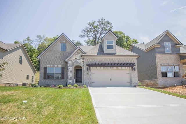 view of front of property with a front yard, brick siding, concrete driveway, and a garage