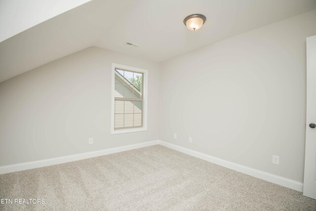 additional living space featuring baseboards, lofted ceiling, and carpet
