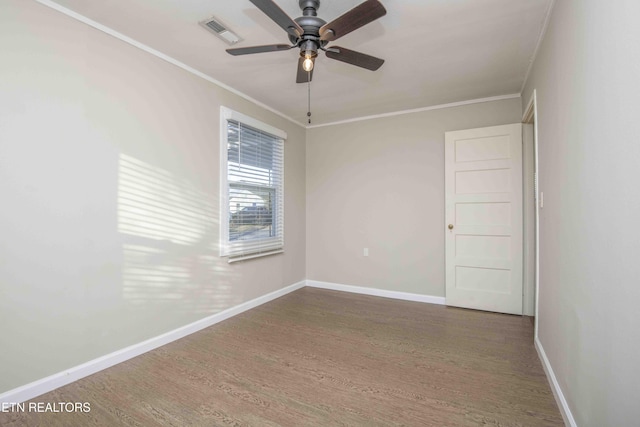 unfurnished room with baseboards, visible vents, wood finished floors, and ornamental molding