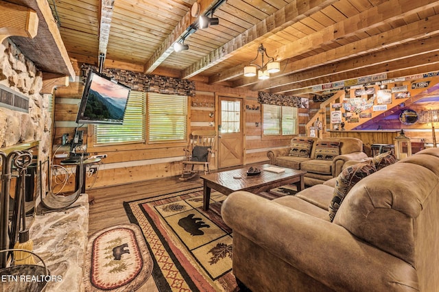 living room with wood walls, rail lighting, wood ceiling, and wood finished floors