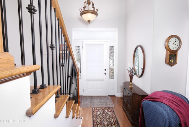 foyer entrance with stairway and wood finished floors