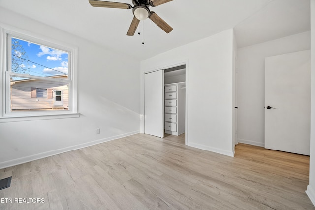 unfurnished bedroom featuring ceiling fan, a closet, wood finished floors, and baseboards