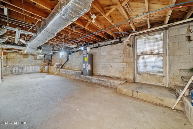 unfinished below grade area featuring water heater