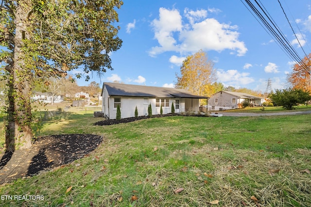 rear view of house with a yard