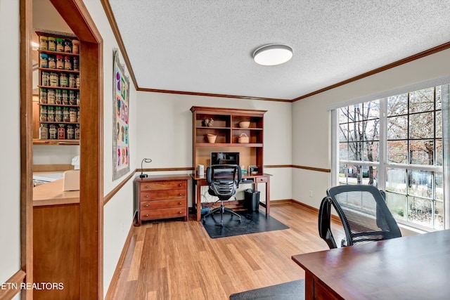 office area featuring ornamental molding, light wood-style floors, a textured ceiling, and baseboards