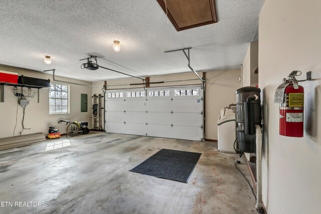 garage with electric panel and a garage door opener