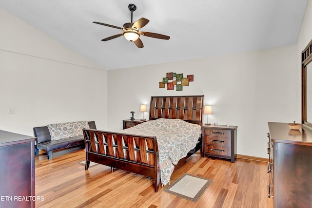 bedroom with a ceiling fan, light wood-type flooring, vaulted ceiling, and baseboards