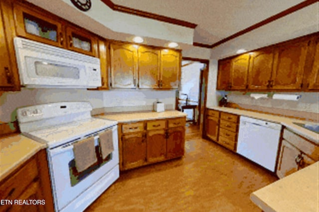 kitchen with light countertops, white appliances, and brown cabinetry