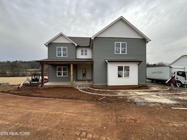 view of front of home with covered porch and a shingled roof