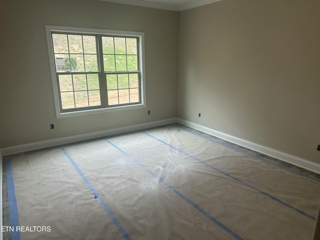 spare room with baseboards