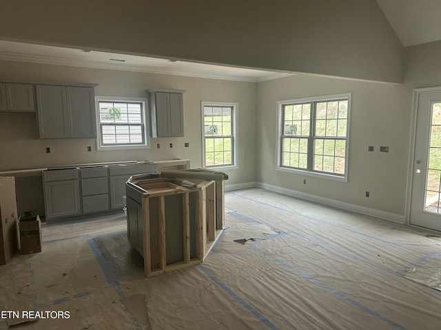 kitchen with ornamental molding, a healthy amount of sunlight, baseboards, and gray cabinetry