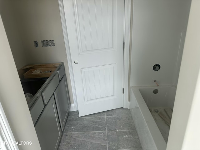 bathroom featuring vanity and marble finish floor