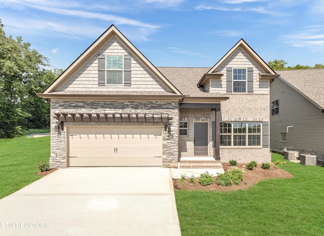 craftsman-style home featuring stone siding, driveway, central AC, and a front lawn