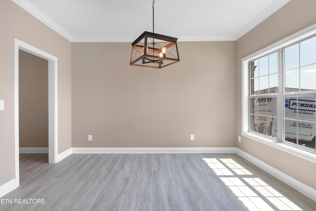 unfurnished dining area featuring crown molding, a chandelier, and a wealth of natural light