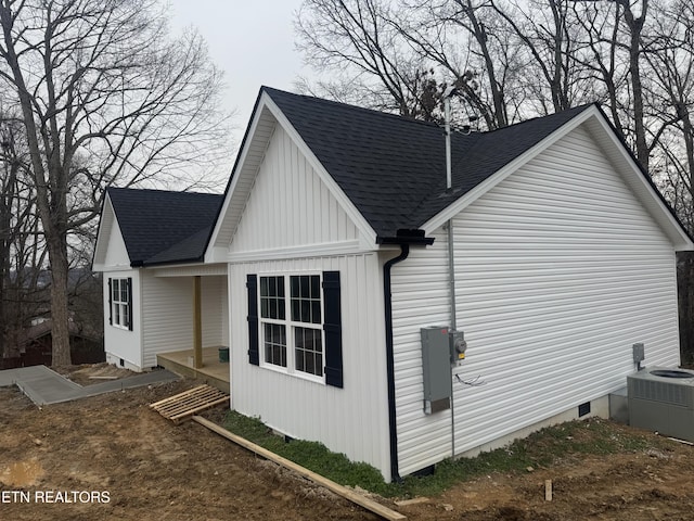 view of property exterior featuring crawl space, roof with shingles, and central AC