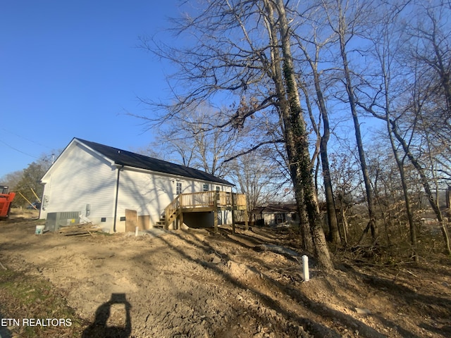 back of house featuring stairs, a wooden deck, and crawl space