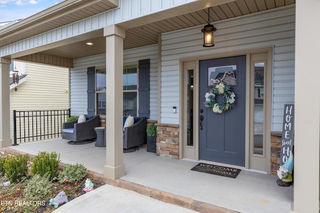 entrance to property with covered porch and board and batten siding