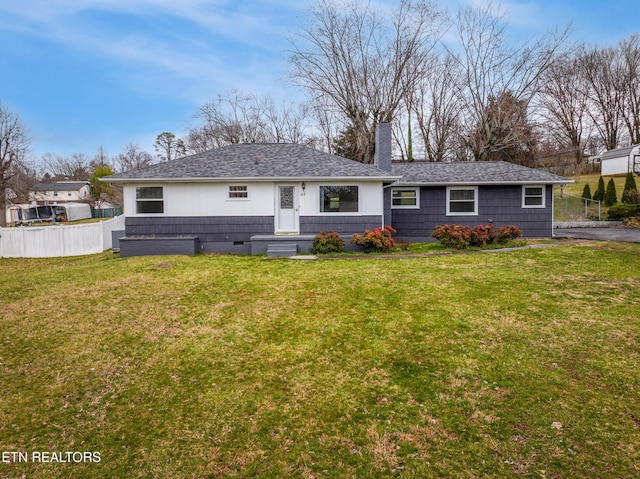 back of house with crawl space, a chimney, fence, and a lawn