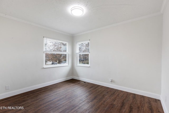 unfurnished room with ornamental molding, dark wood-style flooring, visible vents, and baseboards