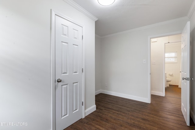 interior space with dark wood-style flooring, crown molding, and baseboards