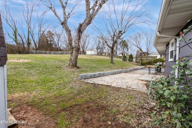 view of yard with fence and a patio