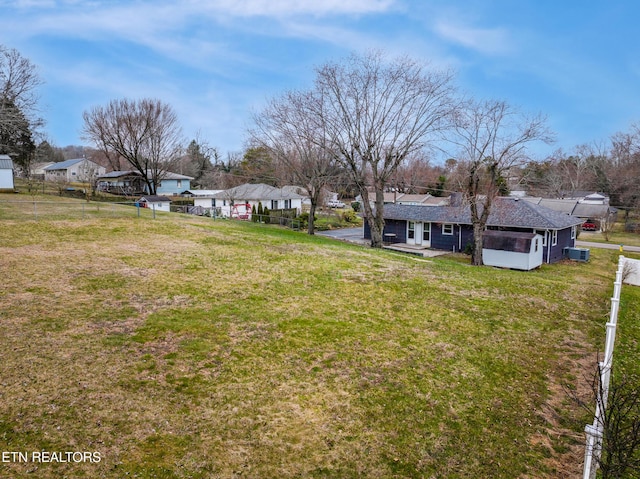 view of yard featuring a residential view and fence