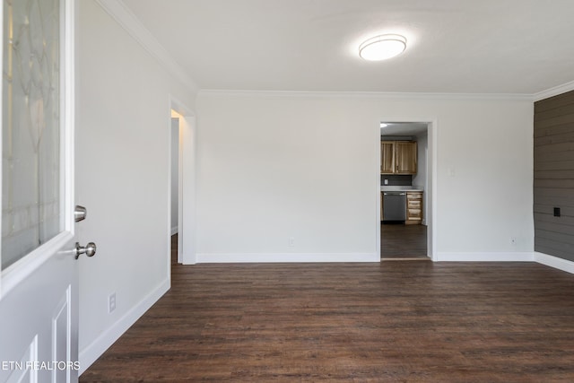 unfurnished room with dark wood-style flooring, crown molding, and baseboards