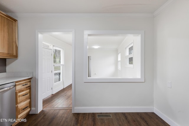 unfurnished dining area with ornamental molding, dark wood finished floors, and baseboards