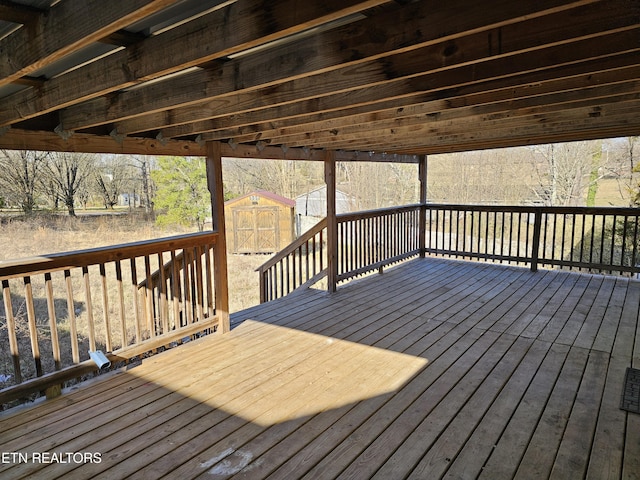 wooden terrace with an outbuilding and a shed