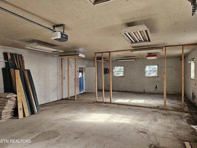 parking garage with concrete block wall and a garage door opener