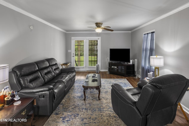 living room with baseboards, ceiling fan, ornamental molding, and wood finished floors