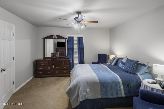 carpeted bedroom featuring baseboards and a ceiling fan