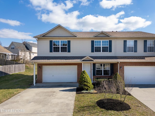 view of front of house featuring a garage, brick siding, fence, concrete driveway, and a front yard