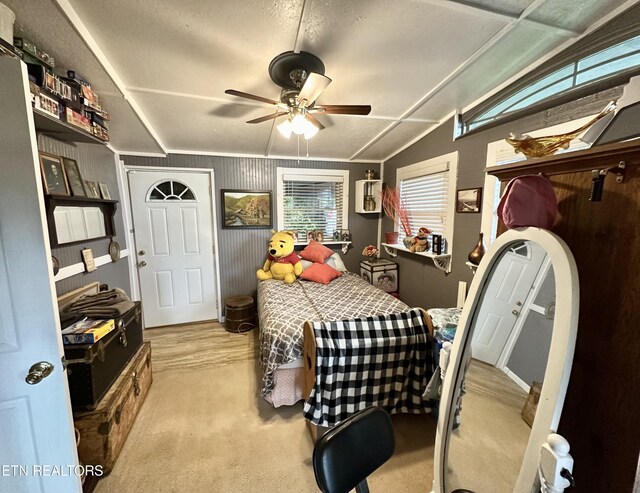 bedroom featuring lofted ceiling, carpet, and ceiling fan