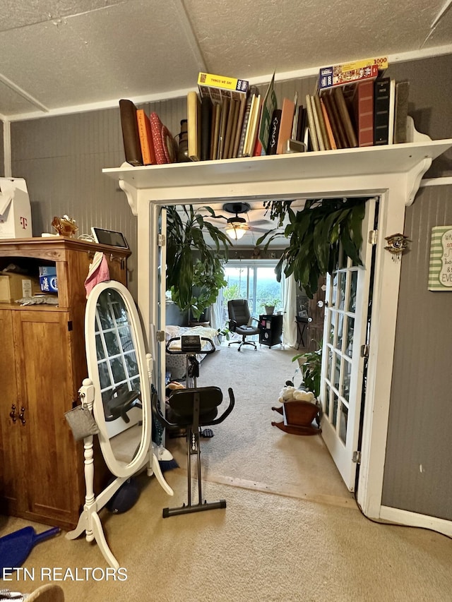 exercise room with carpet and a textured ceiling