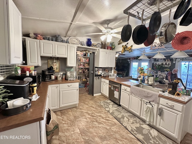 kitchen featuring a ceiling fan, white cabinetry, a sink, dishwasher, and a peninsula