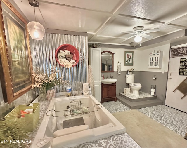 bathroom with toilet, coffered ceiling, vanity, a ceiling fan, and a bath