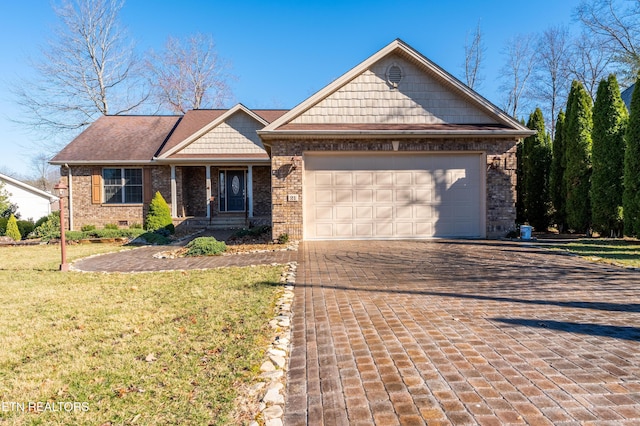 view of front facade with a garage, brick siding, decorative driveway, and a front yard