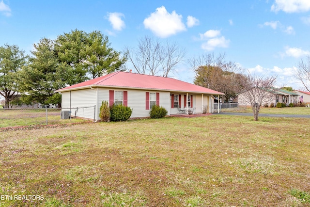 single story home featuring a front yard, central air condition unit, fence, and metal roof