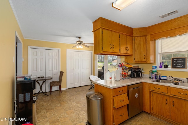 kitchen featuring dishwasher, light countertops, visible vents, and a sink