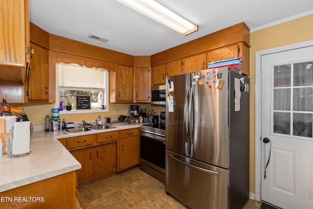 kitchen featuring a sink, light countertops, brown cabinets, and stainless steel appliances