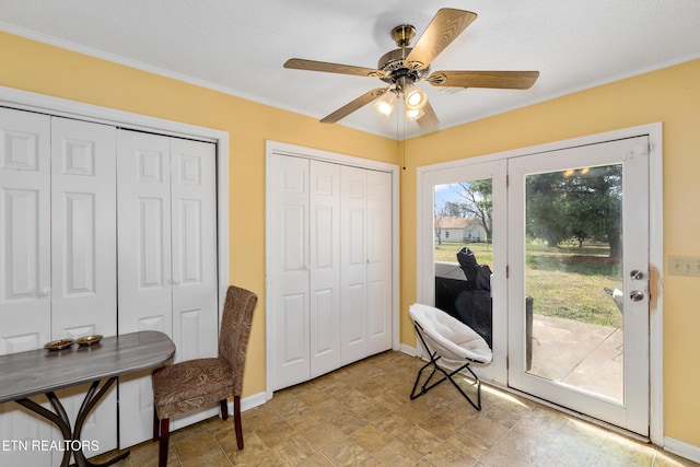 home office featuring crown molding, baseboards, and ceiling fan