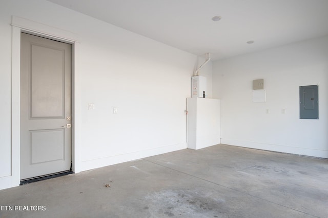 garage with electric panel and baseboards