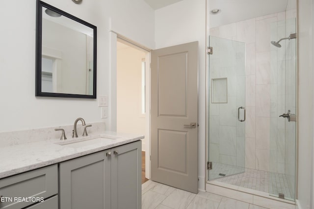 full bathroom with a stall shower, marble finish floor, and vanity